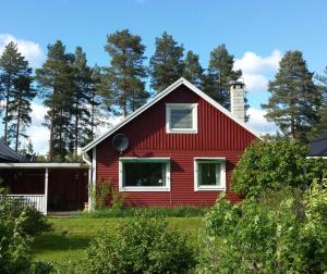 VidselにあるVilla Tallの白窓と木々のある赤い家