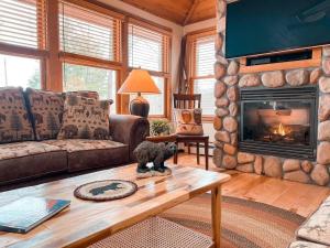 a living room with a couch and a fireplace at The Tinker Bell on Ossipee Lake in Ossipee