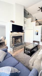 a living room with a couch and a fireplace at Lake and Ski Escape with Hot Tub Coming Soon in Lake Harmony