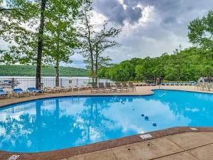 a large swimming pool with tables and chairs at Lake and Ski Escape with Hot Tub Coming Soon in Lake Harmony