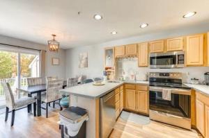 a kitchen with a table and a dining room at Lake and Ski Escape with Hot Tub Coming Soon in Lake Harmony