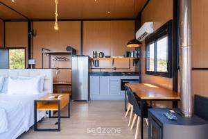 1 dormitorio y cocina con cama y mesa en Cabaña con chimenea e hidromasaje! VST044, en Annitapolis