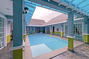 a swimming pool in the middle of a building at Luxury Villa Monterez Club Golf, Shah Alam - Smarthome in Shah Alam