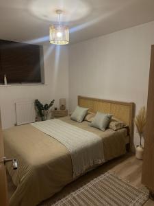 a bedroom with a large bed with two pillows at Modern Refurbished Apt in Stevenage Town Centre in Stevenage