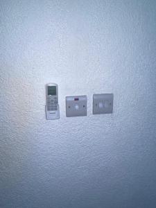 a cell phone is plugged into an electrical outlet at Kingdom Rentals - AirBnCar in Roseau