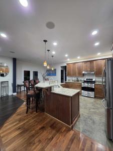 a large kitchen with wooden cabinets and a large island at Eaglemont Golf Course Peaceful Retreat in Mount Vernon