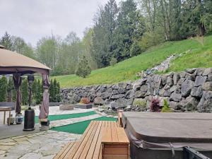 a backyard with a pool and a stone wall at Eaglemont Golf Course Peaceful Retreat in Mount Vernon