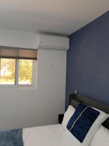 a bedroom with a white bed and a window at Small's Cozy Rest 6 Efficiency 