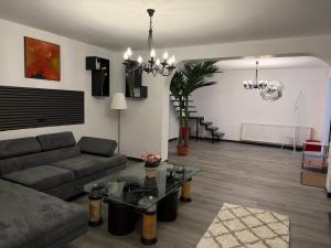 a living room with a couch and a table at Central Villa in Craiova +30 photos