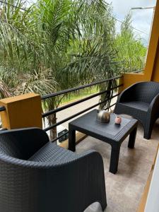 a balcony with two chairs and a table and chairs at Depto. a estrenar en el corazón de Canning in Canning
