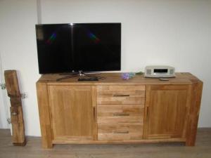 a television on top of a wooden cabinet at Ferienhaus In Winnemark Mit Großem Garten in Winnemark