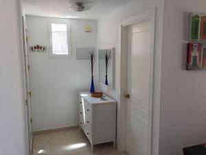 a room with a white door and a white cabinet at Tajinaste Sol in Morro del Jable