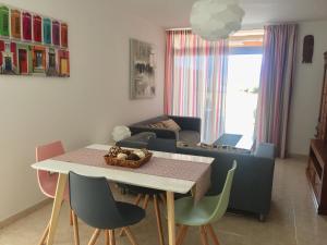 a living room with a table and chairs and a couch at Tajinaste Sol in Morro del Jable