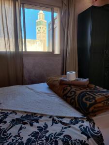 a bedroom with a bed and a window with a clock tower at Casablanca House hassan2 in Casablanca