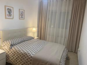 a bedroom with a bed and a window at Edificio TORREMAR vistas al mar, orientación norte, Wifi y Smart-TV in Oropesa del Mar +19 photos
