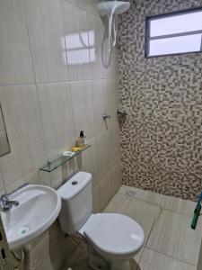a bathroom with a toilet and a sink at Hospedagem do Elias in Cuiabá