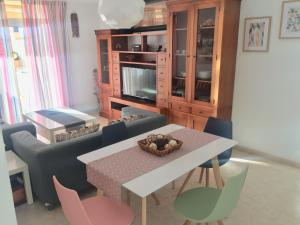 a living room with a table and chairs at Tajinaste Sol in Morro del Jable