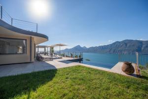a house with a view of the water at Alleinstehende Villa Mit Pool Und Traumaussicht in Castelletto di Brenzone