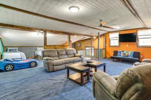 a living room with furniture and a bed and a car at Bayview - Lakefront Family Cabin in Odessa! in Odessa