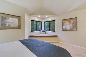 a bedroom with a bed and two windows at River Ridge 428B - Meredith Lodging in Bend +19 photos