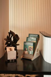 a book sitting on top of a table with a couple at Z Hotel Sfax in Sfax