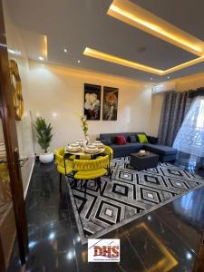 a living room with a table and a couch at DHSimmo Cozy home in Rufisque