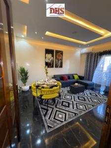 a living room with a table and a couch at DHSimmo Cozy home in Rufisque +2 photos