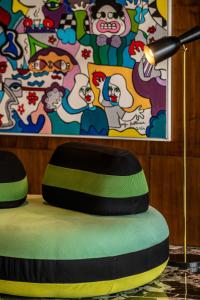a table topped with a bean bag chair next to a painting at Z Hotel Sfax in Sfax