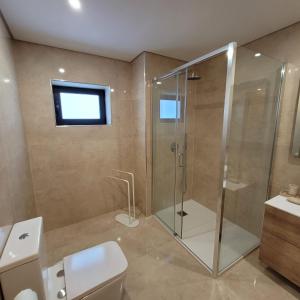 a bathroom with a shower and a toilet and a sink at Gerescasadapraia in Geres
