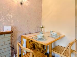 a wooden table with two cups and saucers on it at Lilac Studio in Wheldrake