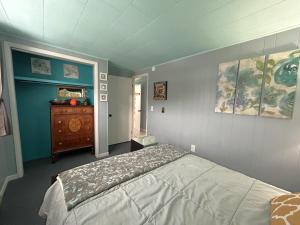 a bedroom with a bed and a dresser in it at Bayview #1 in Saint Ignace