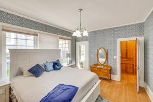 a bedroom with a large bed and a mirror at 1 Mi to Pendleton Round-Up Historic Elnor Home in Pendleton