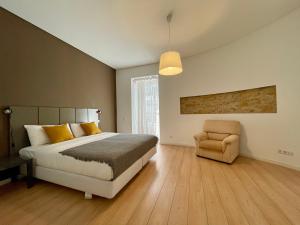 a bedroom with a bed and a chair at Lisboa Arroios Apartment in Lisbon