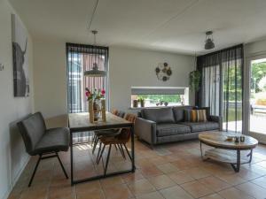 a living room with a couch and a table at Busch en Dam in Uitgeest +19 photos