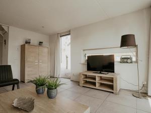 a living room with a flat screen tv on a wall at Dorregeest in Uitgeest