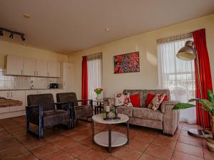 a living room with a couch and a table at Waterbase in Uitgeest