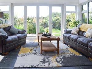 a living room with a couch and a coffee table at Benlli in Aberdaron