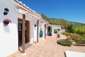 ein Innenhof eines weißen Hauses mit Blumen darauf in der Unterkunft Ferienhaus für 4 Personen und 2 Kinder in Coares, Andalusien Costa del Sol in Comares + 32 Fotos