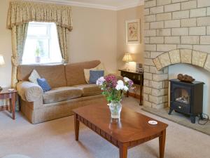 a living room with a couch and a fireplace at Ferguson in Warenford