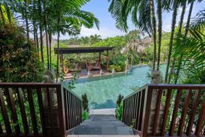 منتجع ساهاجا سواه في تابانان: مسبح منتجع مع جسر وأشجار نخيل