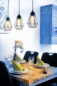 a dining room table with three lights hanging over it at Appartement Mit Balkon in Bad Koetzting