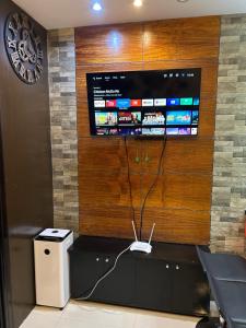 a wall with a tv with a wii controller on it at R and RMI CONDOTEL in Baguio