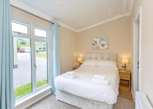 a bedroom with a bed and a large window at Bainbridge Ings in Hawes +56 photos