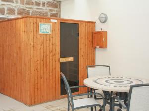 a room with a table and a wooden door at The Granary Cottage in Warenford