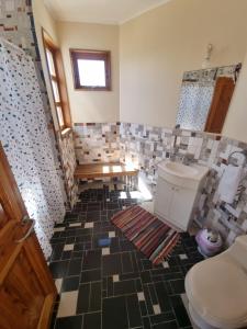 a bathroom with a toilet and a table in it at Pedal Paradise Tongoy in Tongoy +53 photos