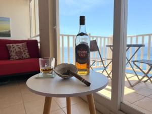 a bottle of wine on a table with a glass at Departamento B84 in Puchuncaví