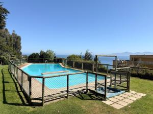 a swimming pool with a fence around it at Departamento B84 in Puchuncaví