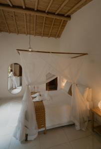 a bedroom with a bed with mosquito nets at Villa Cacau - Floresta in Trancoso