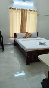 a bedroom with two beds and a window at Mount Teena in Anachal