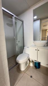 a bathroom with a toilet and a sink and a mirror at Habitación Matrimonial en el centro de la ciudad in Ayacucho